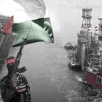 Photo composition showing an offshore oil rig platform, the Palestinian flag and a small rocket launcher guarded by armed fighters. Photo: The Cradle.