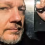 Julian Assange inside a prison van heading for London’s high-security Belmarsh Prison, where he has been imprisoned for three years pending a decision by the UK courts on an extradition request by the US Department of Justice. Photo: Getty Images.