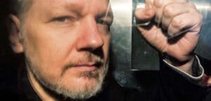 Julian Assange inside a prison van heading for London’s high-security Belmarsh Prison, where he has been imprisoned for three years pending a decision by the UK courts on an extradition request by the US Department of Justice. Photo: Getty Images.