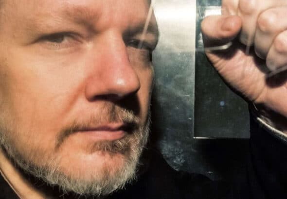 Julian Assange inside a prison van heading for London’s high-security Belmarsh Prison, where he has been imprisoned for three years pending a decision by the UK courts on an extradition request by the US Department of Justice. Photo: Getty Images.