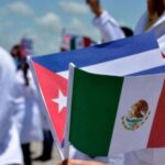 A Cuban doctor holding flags of Mexico and Cuba during a public ceremony. File photo.