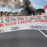 Strikers walking in the streets with a banner saying low cost of living. Photo: Suntracs.