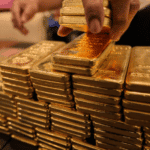 Gold ingots being piled on a table. Photo: Getty Images.