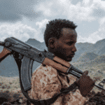 Man with a weapon over his shoulder. File photo.