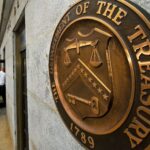 Entrance to the US Department of the Treasure with a closeup to its coat of arms. File photo.