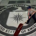 The CIA logo with a janitor cleaning it. Photo: EPA