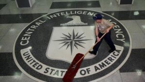 The CIA logo with a janitor cleaning it. Photo: EPA