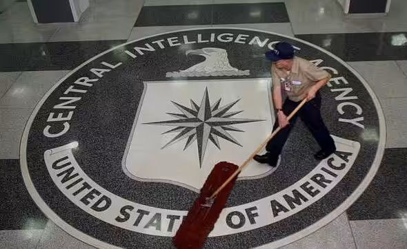 The CIA logo with a janitor cleaning it. Photo: EPA