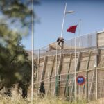 A man trying to jump the border fence in the Spanish colonial enclave of Melilla in Morocco. Photo: Javier Bernardo.