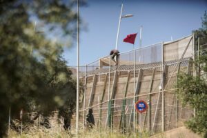 A man trying to jump the border fence in the Spanish colonial enclave of Melilla in Morocco. Photo: Javier Bernardo.