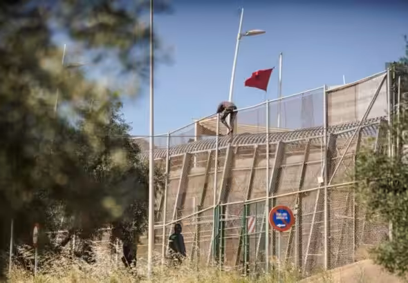 A man trying to jump the border fence in the Spanish colonial enclave of Melilla in Morocco. Photo: Javier Bernardo.