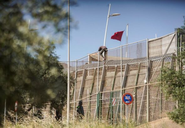 A man trying to jump the border fence in the Spanish colonial enclave of Melilla in Morocco. Photo: Javier Bernardo.