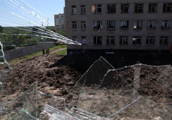 A large crater is visible in a school yard from overnight shelling as Russia’s attack on Ukraine continues in Kharkiv, Ukraine, on June 27. Photo: Leah Millis/Reuters.