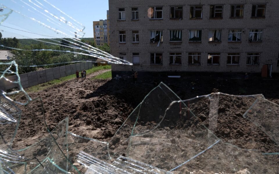 A large crater is visible in a school yard from overnight shelling as Russia’s attack on Ukraine continues in Kharkiv, Ukraine, on June 27. Photo: Leah Millis/Reuters.