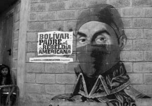 Street art showing Simon Bolivar wearing a balaclava next to a banner that reads: "Bolivar, father of the American Rebellion." Art: Comando Creativo.