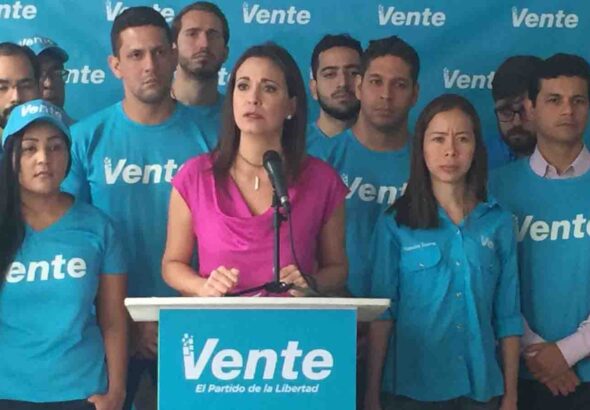 María Corina Machado speaking surrounded by members of her political organization. File photo.