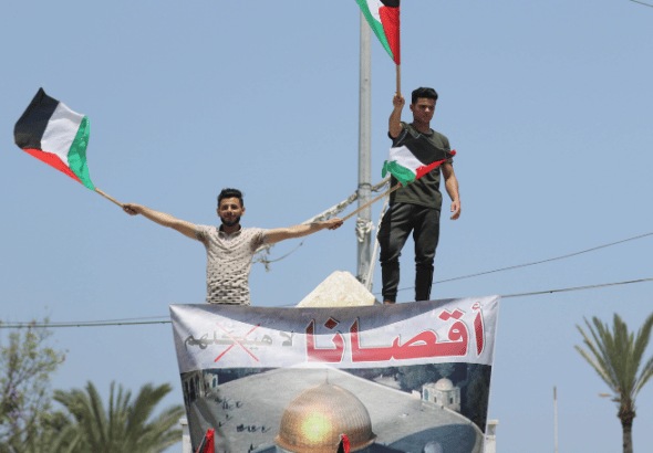 Palestinians take part in a rally in Gaza. Photo: Mahmoud Ajjour, The Palestine Chronicle.