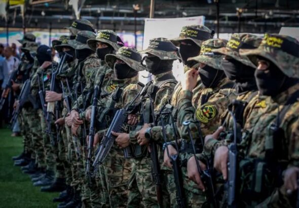 Members of Al-Quds Brigades, the military wing of the Islamic Jihad movement at a gathering for Islamic Jihad commander Khaled Mansour, who was killed on the first day of “Operation Breaking Dawn”, in Rafah, in the southern Gaza Strip, on August 8, 2022 (photo credit: ABED RAHIM KHATIB/FLASH90)