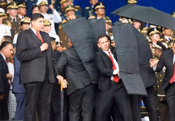 Seconds after the first drone explosion, while the presidential security detail was evacuating President Maduro from the stage during the assassination attempt. File photo.