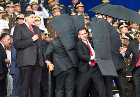 Seconds after the first drone explosion, while the presidential security detail was evacuating President Maduro from the stage during the assassination attempt. File photo.