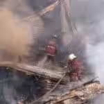 Firefighters work to extinguish the fire at the IVSS warehouse where dialysis machines and medical supplies had been stored. Photo: Rayner Peña R.