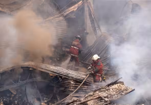 Firefighters work to extinguish the fire at the IVSS warehouse where dialysis machines and medical supplies had been stored. Photo: Rayner Peña R.