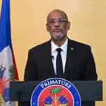 Ariel Henry, Haiti’s de facto prime minister, addresses the nation on the first anniversary of his being named to the post by the "Core Group" of foreign ambassadors. Photo: Haïti Liberté.