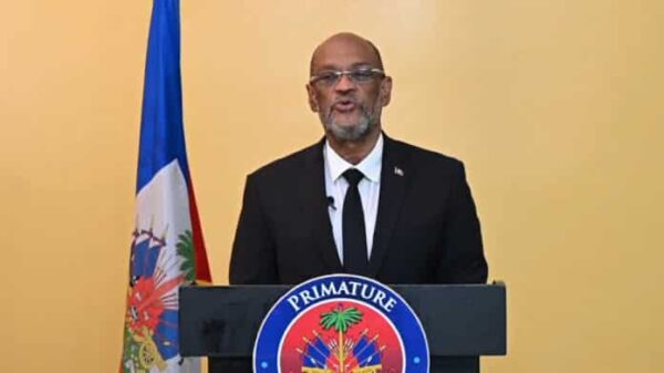 Ariel Henry, Haiti’s de facto prime minister, addresses the nation on the first anniversary of his being named to the post by the "Core Group" of foreign ambassadors. Photo: Haïti Liberté.