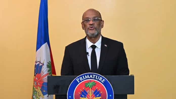 Ariel Henry, Haiti’s de facto prime minister, addresses the nation on the first anniversary of his being named to the post by the "Core Group" of foreign ambassadors. Photo: Haïti Liberté.
