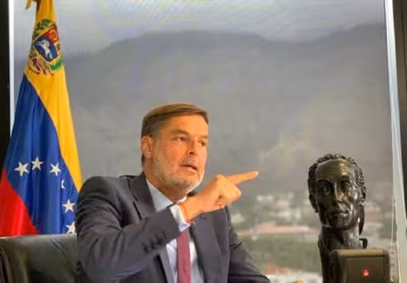 Félix Plasencia, the new Venezuelan ambassador to Colombia and former minister for foreign affairs, next to a sculpture of Simon Bolivar and the Venezuelan flag in an office showing the Warairarepano mountain of Caracas in the background. File photo.