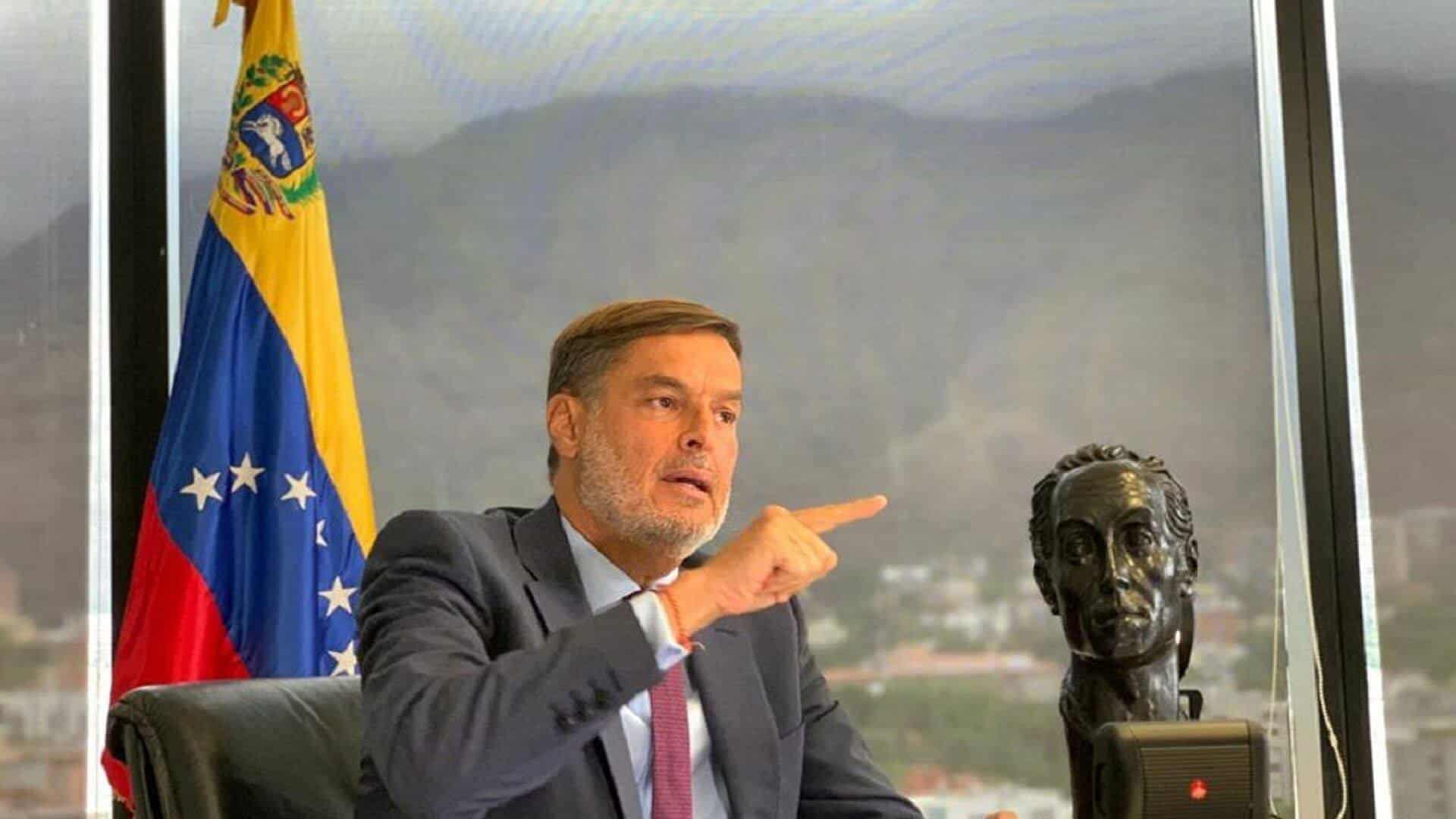Félix Plasencia, the new Venezuelan ambassador to Colombia and former minister for foreign affairs, next to a sculpture of Simon Bolivar and the Venezuelan flag in an office showing the Warairarepano mountain of Caracas in the background. File photo.