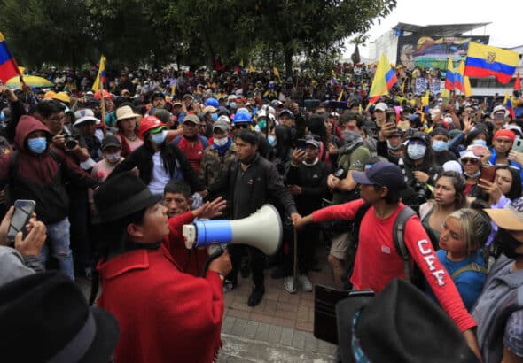 An Ecuadorian protest leader addresses some demonstrators with a megaphone. File photo.