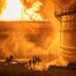Firefighters try to control the flames in a fuel tank during the early hours of Saturday, August 6, in Matanzas, Cuba. Photo: Twitter/@BrunoRguezP