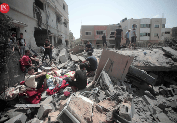Palestinians among the rubble of a destroyed city block in Gaza. Photo: Mahmoud Ajjour/The Palestine Chronicle.