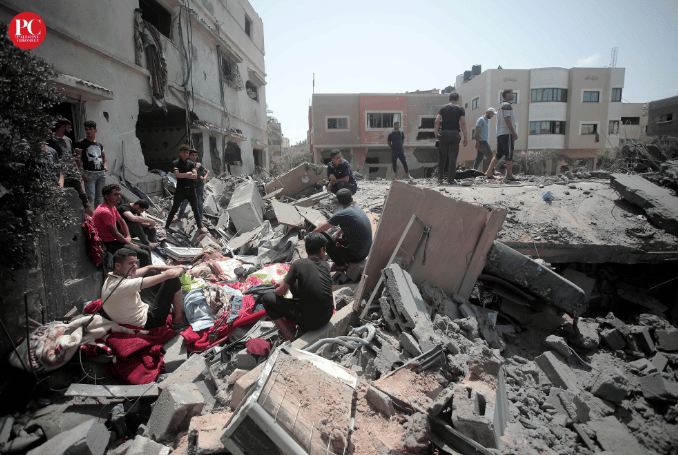 Palestinians among the rubble of a destroyed city block in Gaza. Photo: Mahmoud Ajjour/The Palestine Chronicle.