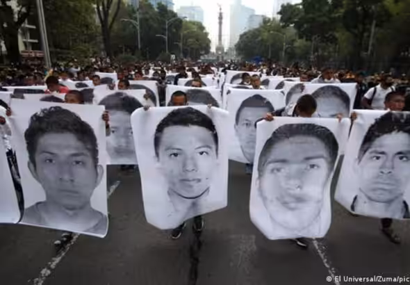 Demonstration with protesters holding human size portraits of each of the Ayotzinapa victims, at Paseo de la Reforma in Mexico City. Photo: El Universal/Zuma/Picture Alliance.