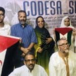 Members of Sahrawi human rights organization CODESA hold the flag of the Sahrawi Arab Democratic Republic as they present their first report on war crimes by Morocco in Western Sahara. Photo: CODESA.