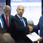 Former Argentinian Ambassador in Venezuela Óscar Laborde (center front) receiving a Venezuelan parliamentary resolution condemning the hijacking of the Venezuelan Boeing 747-300 by Argentinian authorities, from Venezuelan Deputy Pedro Carreño (left), and Venezuelan Minister for Transport Ramón Velásquez (right). Photo: Infobae.