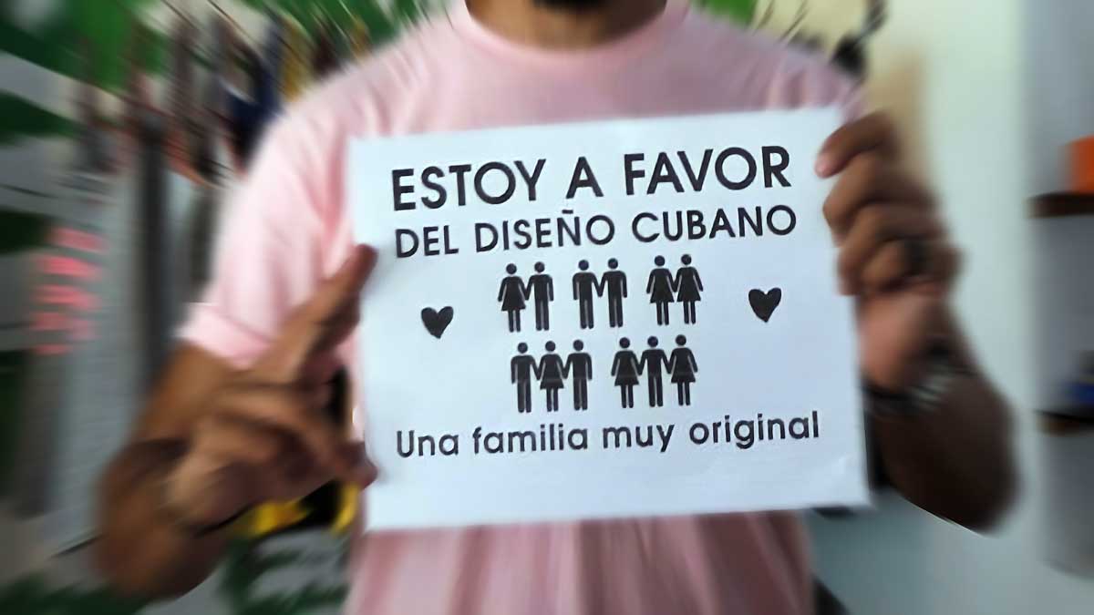 A person holds a sign that reads: "I am in favor of Cuban design" (figures of people appear in the sign where there are women-men, men-men, women-women, men-women-men and women-men- women) and ends with: A very original family. File photo.