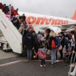 Passengers boarding a Venezuela's state owned Conviasa flight. The Venezuelan government has repatriated thousands of Venezuelans with the Vuelta a la Patria program. File photo.