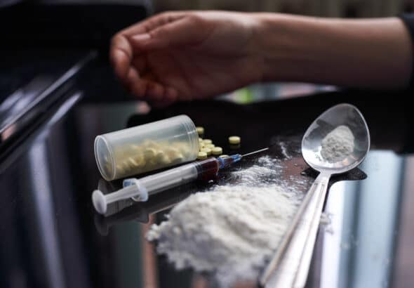 The state of humanity, as a drug addict, dying by its own over consumption.