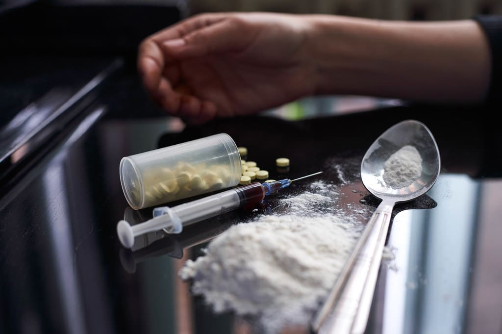 The state of humanity, as a drug addict, dying by its own over consumption.