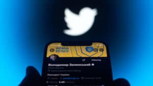 Smartphone screen showing Vladimir Zelensky Twitter account, with the Twitter logo in the background. Photo: NurPhoto via Getty Images.