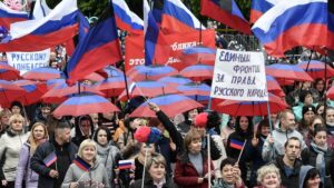 People protesting with Russian flags and with signs in Russian language. Photo: Sputnik/Konstantin Mikhalchevsky.