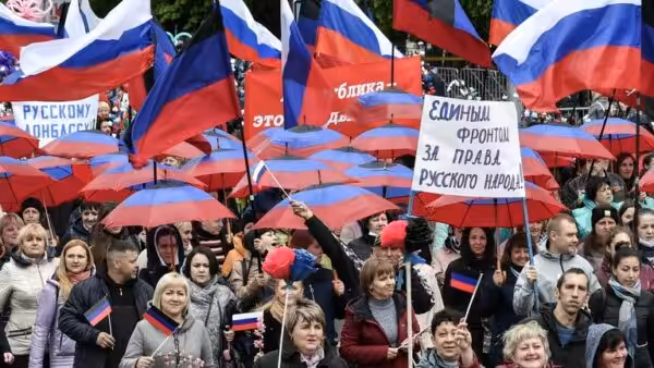 People protesting with Russian flags and with signs in Russian language. Photo: Sputnik/Konstantin Mikhalchevsky.