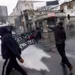 Protesters being attacked with a water cannon during a march on the day that marks the 49th anniversary of the coup against Salvador Allende in Chile. Photo: EFE.