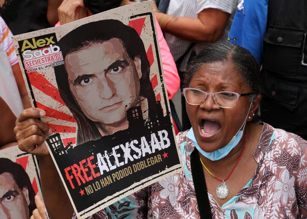 Venezuelan woman demanding in a street protest for the freedom of ambassador Alex Saab while holding a banner with a photo of the diplomat that reads: "Alex Saab kidnapped by the Empire, #FreeAlexSaab, they haven't been able to bend him." File photo.