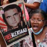 Venezuelan woman demanding in a street protest for the freedom of ambassador Alex Saab while holding a banner with a photo of the diplomat that reads: "Alex Saab kidnapped by the Empire, #FreeAlexSaab, they haven't been able to bend him." File photo.