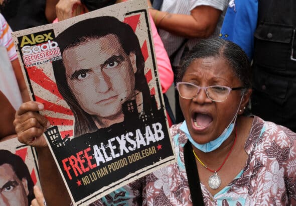 Venezuelan woman demanding in a street protest for the freedom of ambassador Alex Saab while holding a banner with a photo of the diplomat that reads: "Alex Saab kidnapped by the Empire, #FreeAlexSaab, they haven't been able to bend him." File photo.