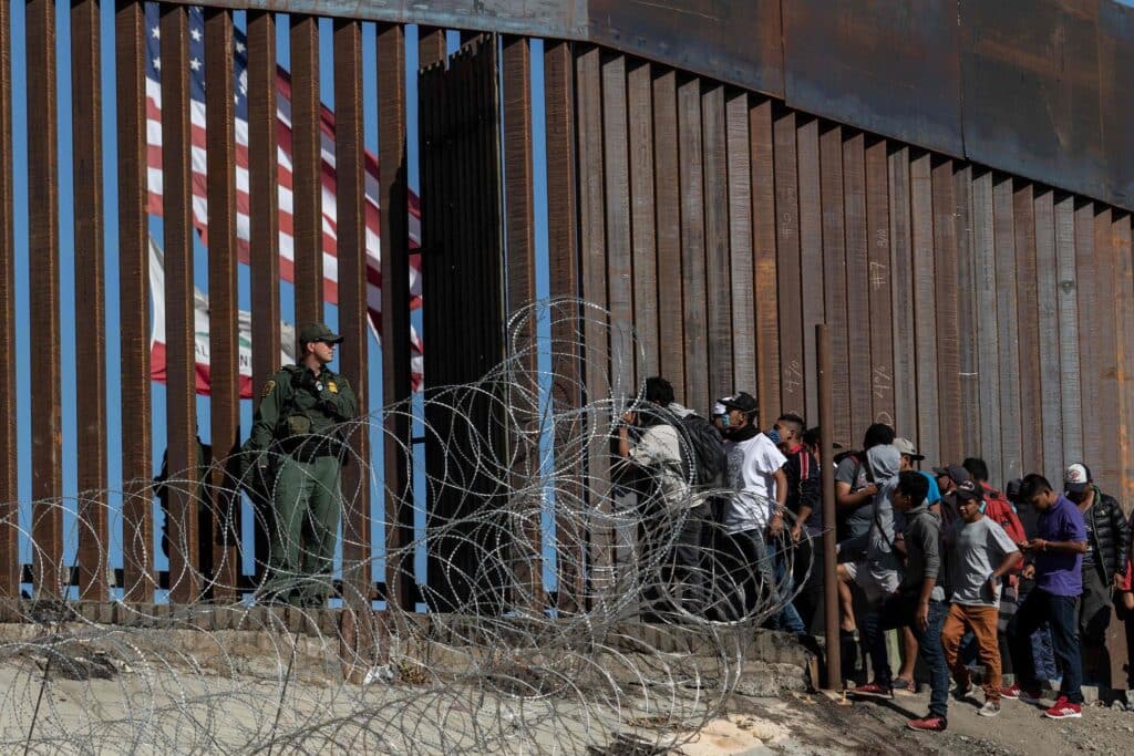 Migrants at a border crossing of the southern US border near Tijuana, Mexico, in 2018. Photo: Guillermo Arias/AFP.